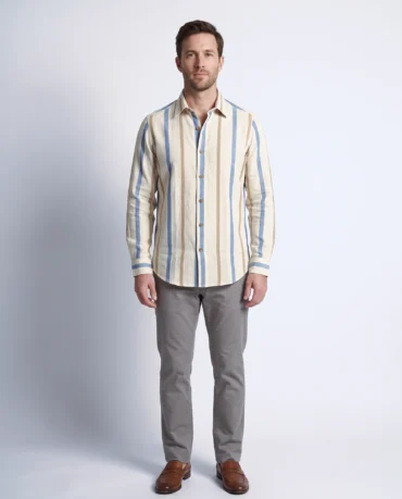 Man wearing the Harbour Sand khadi striped shirt, denim blue and camel stripes on cream, full-length front view