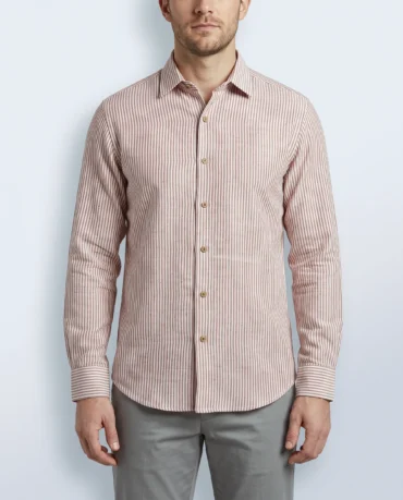 Handwoven khadi shirt in fine terracotta pinstripe on cream, worn untucked, front view with coconut-shell buttons